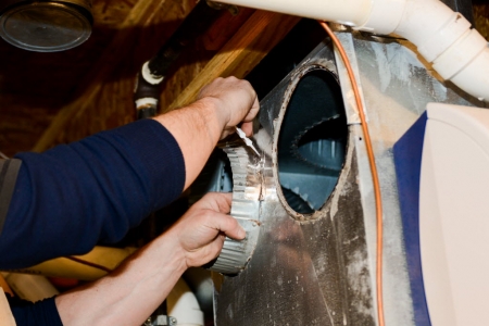 worker installing vent hole